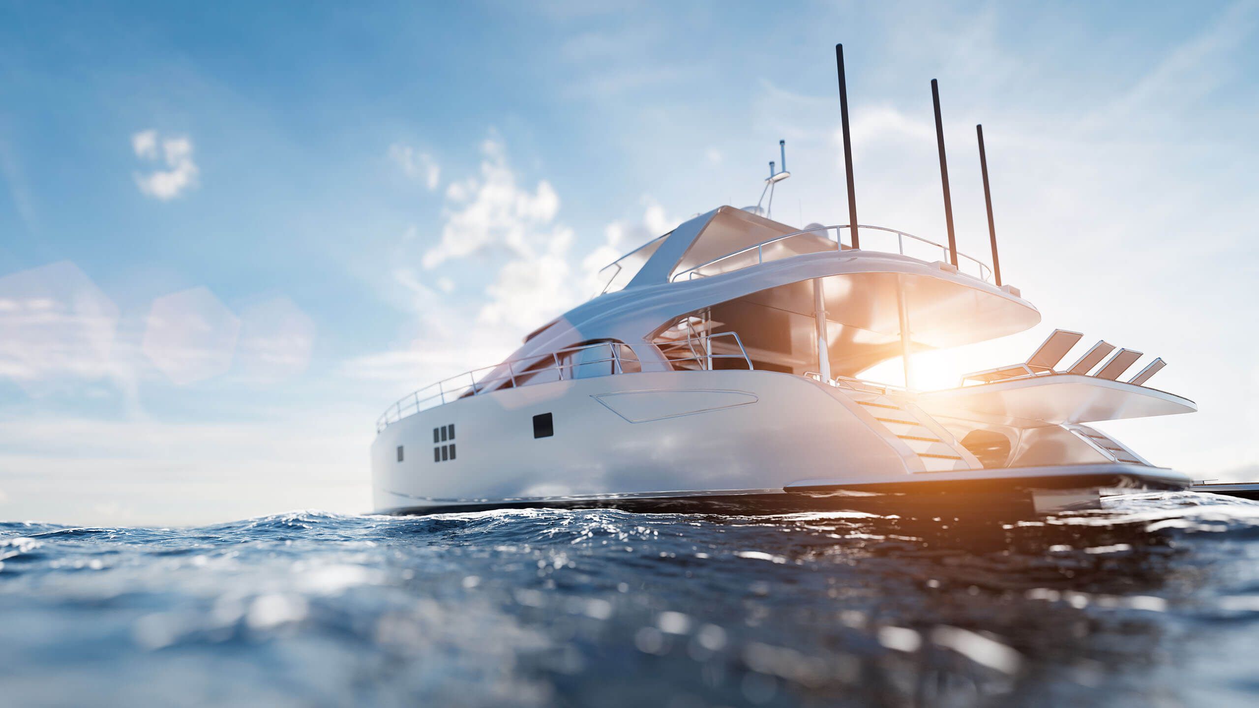 Luxury yacht on the open ocean with sunrise in the background and blue skies and crisp, ocean water