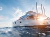 Luxury yacht on the open ocean with sunrise in the background and blue skies and crisp, ocean water